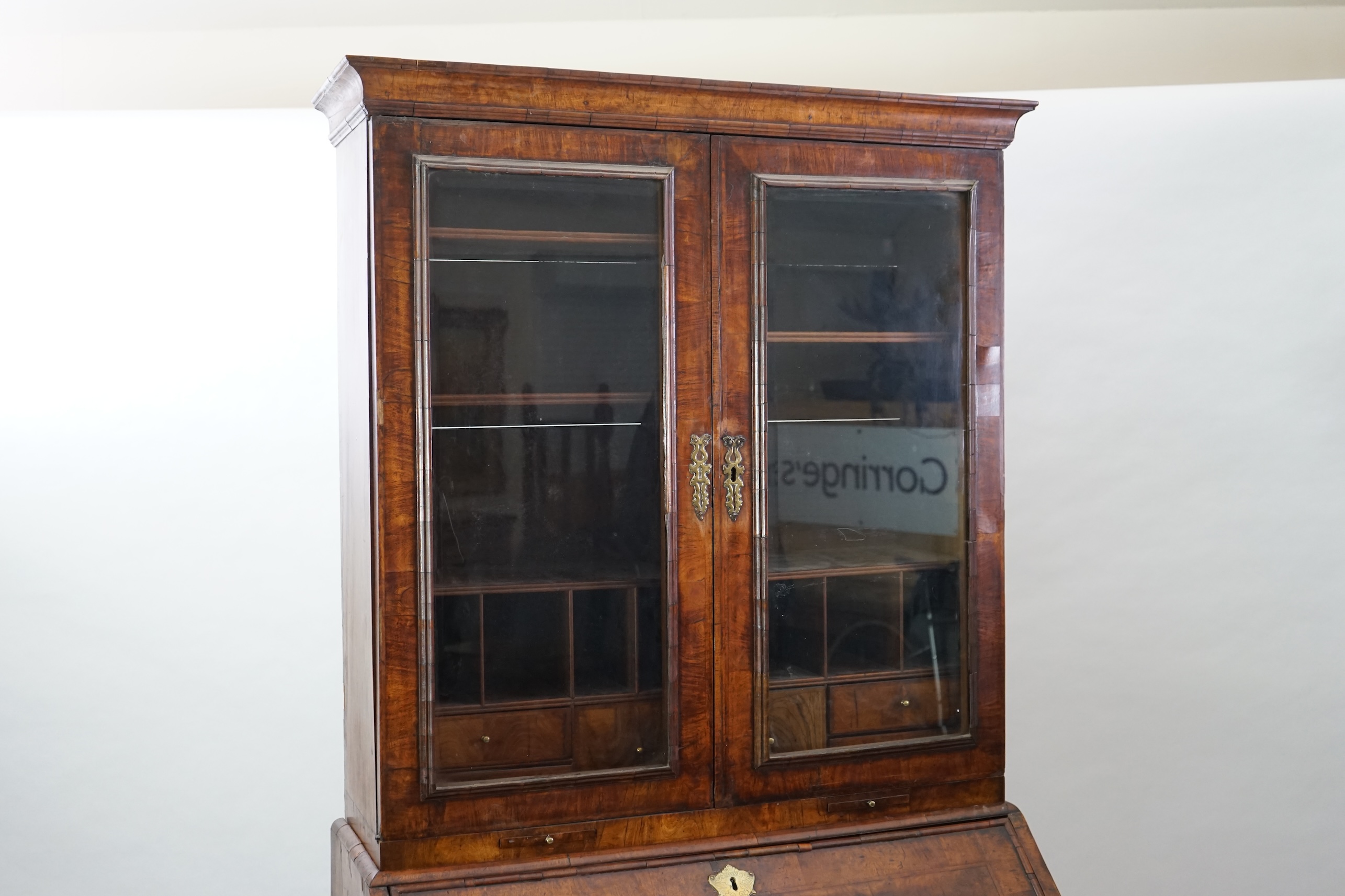 An early 18th century walnut bureau bookcase